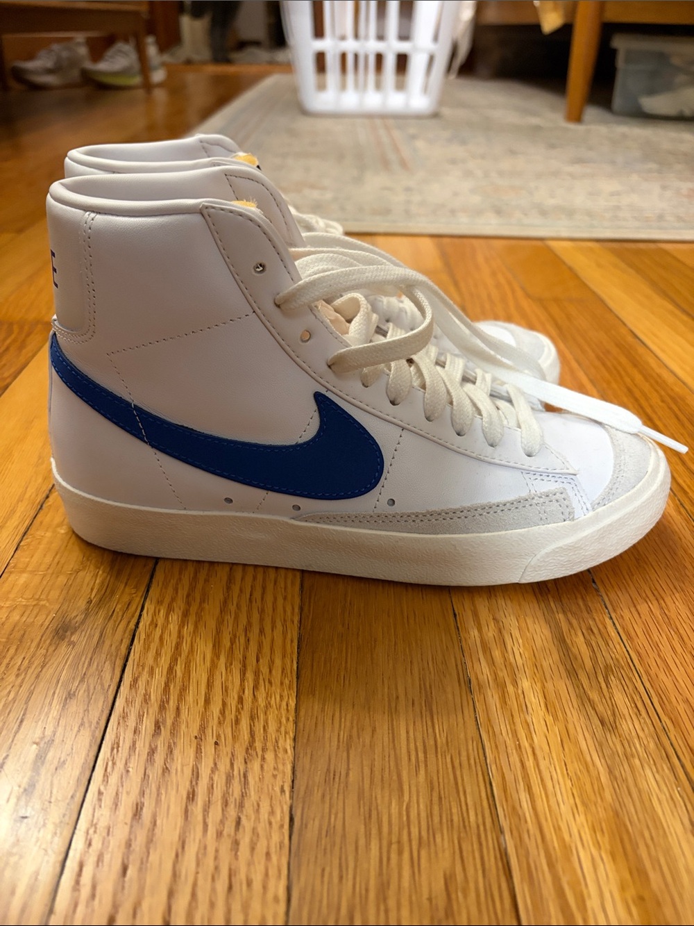 Nike Women’s High-Top Sneakers in White with Blue Swoosh